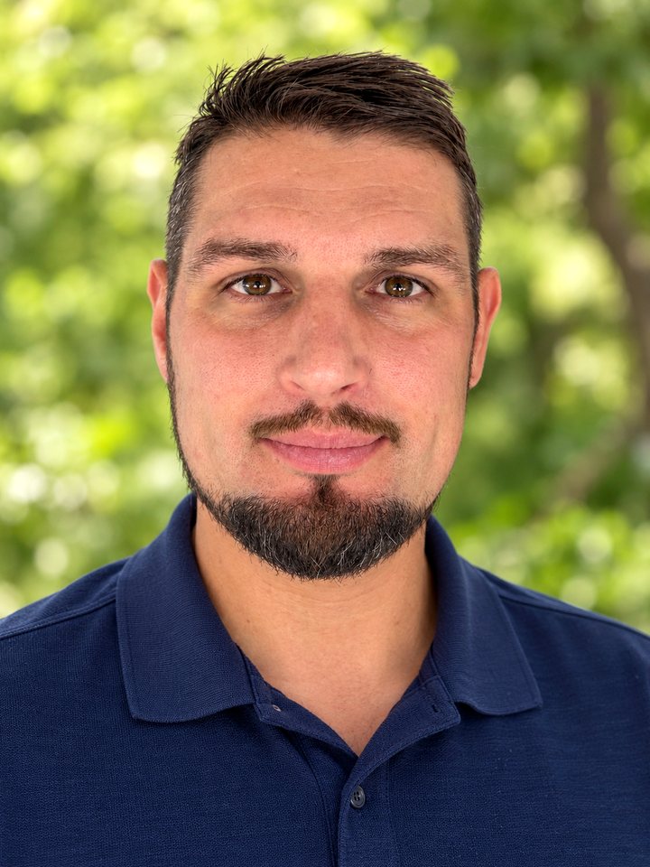 Michael Peluso, founder of True Living, outdoors in a navy polo