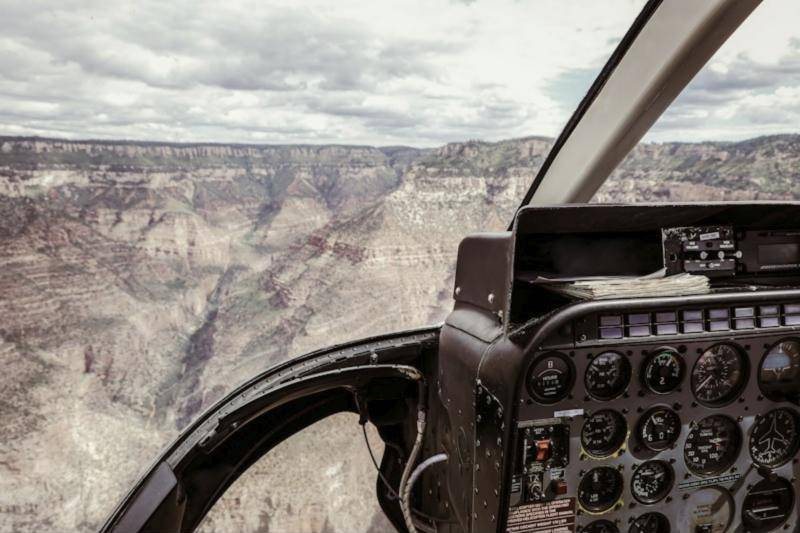 Canyon walls seen through the windshield of a helicopter